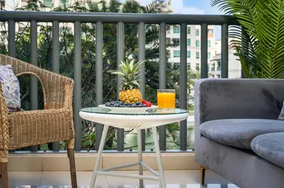 a table with a bowl of fruit and a glass of orange juice at Serene Studio at The Links Canal in Dubai