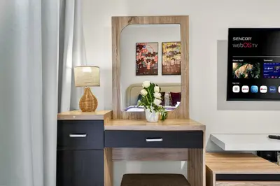 a dressing table with a mirror and a lamp at Serene Studio at The Links Canal in Dubai
