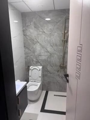 a bathroom with a toilet and a sink at Skyz by Danube Studio Apartment in Arjan , Pool, Gym & Near Miracle Garden in Dubai