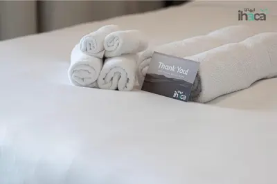 a pile of towels and a book on a bed at 77 Floor Luxury 1Br Marina Sea View Balcony in Dubai