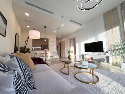 a living room with a couch and a table at Downtown Luxury 1BR with Pool, Gym, Fast WiFi and 8 Min Walk to Burj Khalifa in Dubai