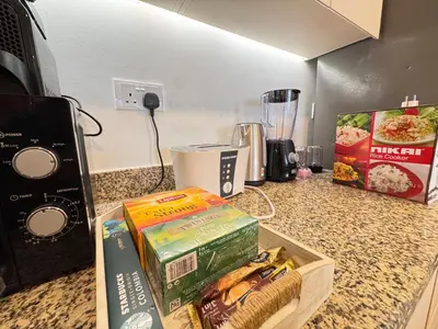a counter top with some books and a blender at Downtown Luxury 1BR with Pool, Gym, Fast WiFi and 8 Min Walk to Burj Khalifa in Dubai