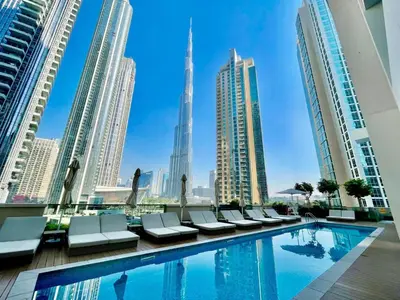 a pool in a city with tall buildings at Burj khalifa in Dubai
