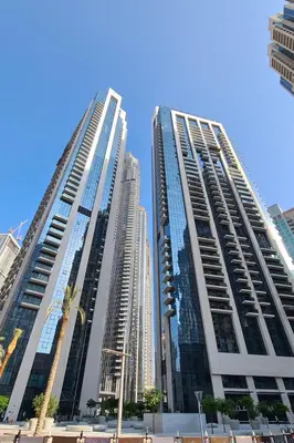 two tall buildings next to each other in a city at Burj khalifa in Dubai