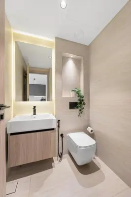 a bathroom with a white sink and a toilet at Modern Apartment w/ Balcony & Rooftop Amenities in Dubai