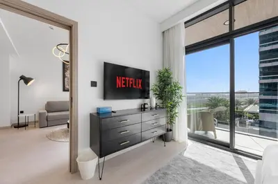 a living room with a television on a dresser at Modern Apartment w/ Balcony & Rooftop Amenities in Dubai