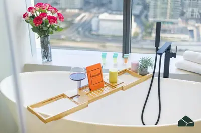 a white table with a vase of flowers and a window at Upgraded 1BR in JW Marriot with Marina View by BMS in Dubai