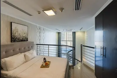 a bedroom with a bed with a table on it at Urban Haven - Peaceful Sanctuary - City Loft in Dubai