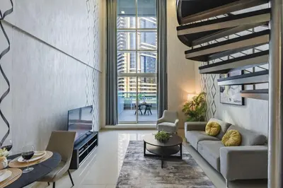 a living room with a couch and a table at Urban Haven - Peaceful Sanctuary - City Loft in Dubai