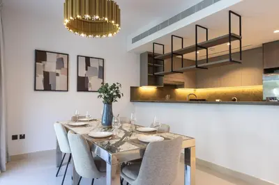 a dining room with a table and chairs at Spacious 3BR Villa plus Maids with Resort-Style Amenities in Tilal Al Ghaf in Dubai