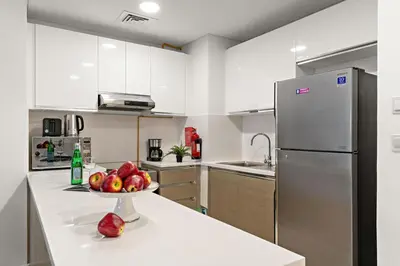 a kitchen with a bowl of fruit on a counter at The Smart Concierge - Andalus Jumeirah Golf Estates in Dubai