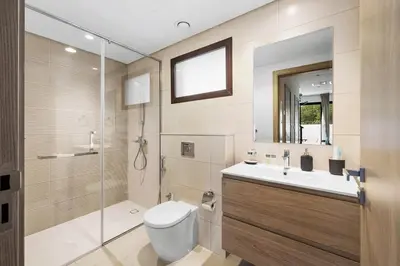 a bathroom with a toilet and a sink and a shower at Family Retreat 3BR Greenwoods Villa in DAMAC Hills in Dubai