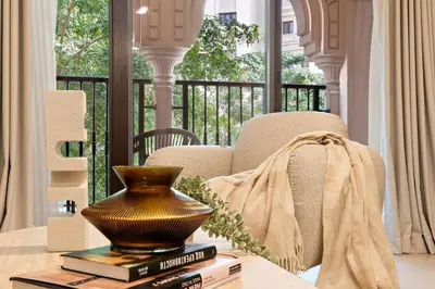 a vase sitting on top of books on a table at The Smart Concierge - Andalus Jumeirah Golf Estates in Dubai
