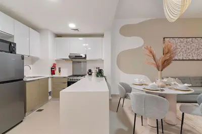 a kitchen with a table and chairs in a kitchen at The Smart Concierge - Andalus Jumeirah Golf Estates in Dubai