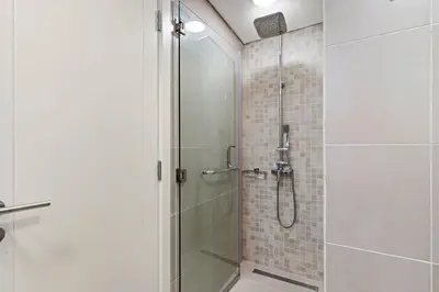 a bathroom with a shower with a glass door at The Smart Concierge - Andalus Jumeirah Golf Estates in Dubai