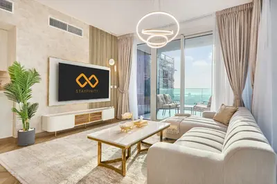 a living room with a couch and a tv at Modern 2BR Apartment with Zabeel Park & Skyline Views in Dubai