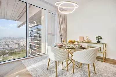 a dining room with a table and chairs and a large window at Modern 2BR Apartment with Zabeel Park & Skyline Views in Dubai