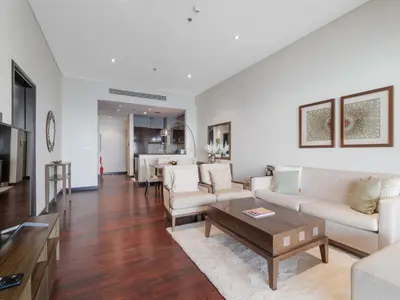 a living room with a couch and a table at Seaside Serenity 1BR Residence in Royal Amwaj in Dubai