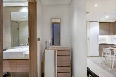 a bathroom with a sink and a mirror at Cozy 1BR with Pool & Gym l 15mn to Downtown in Dubai