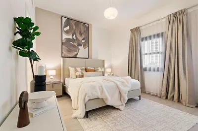 a white bedroom with a bed and a window at The Smart Concierge - Andalus Jumeirah Golf Estates in Dubai
