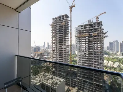 a view of two tall buildings under construction at Warm Glow Retreat Cozy Studio In Regina JVC in Dubai