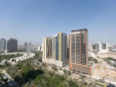 an aerial view of a city with tall buildings at Warm Glow Retreat Cozy Studio In Regina JVC in Dubai