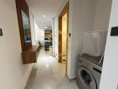 a laundry room with a washer and dryer at Luxurious Two-Bedroom & Living Room Apartment in Dubai