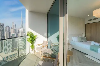 a bedroom with a bed and a view of the city at EasyGo - Chic high floor Studio with Burj View in Dubai