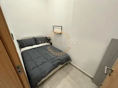 a small bedroom with a bed in the corner at Pantheon Elysee in Dubai