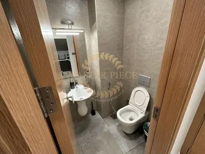 a bathroom with a toilet and a sink at Pantheon Elysee in Dubai