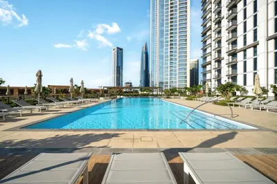 a swimming pool in the middle of a city with buildings at Downtown 4BR Apartment for 12 Guests, Burj and Dubai Mall 5 min in Dubai