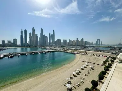 a view of a beach with a city in the background at Vacationer l Modern 1 Bed l Private Beach l Pool, Gym Access in Dubai