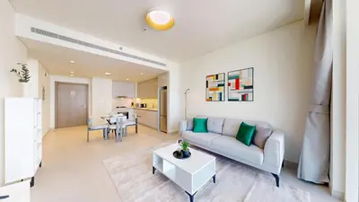 a living room with a couch and a table at Vacationer l Modern 1 Bed l Private Beach l Pool, Gym Access in Dubai