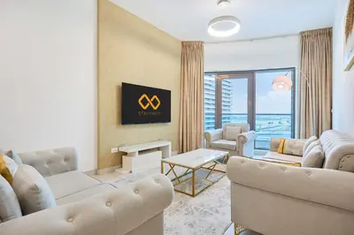 a living room with two couches and a table at Chic 1BR at The Bay - Business Bay Near Burj Khalifa & Dubai Mall in Dubai