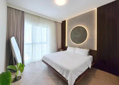 a bedroom with a white bed and a large window at Designer 1BR Dubai Creek Harbour in Dubai