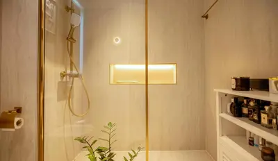 a shower with a glass door in a bathroom at Designer 1BR Dubai Creek Harbour in Dubai
