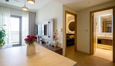 a living room with a vase of flowers on a table at Designer 1BR Dubai Creek Harbour in Dubai