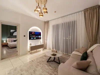 a living room with a couch and a table at Luxury 2BR- Pool with Burj View- 5 Min to Dubai Mall in Dubai