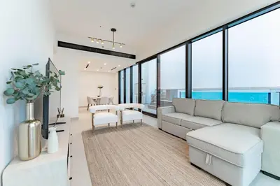 a living room with a couch and a table at HAVN - 2 Bed with Private Pool, JVC in Dubai