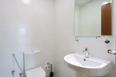 a white bathroom with a sink and a toilet at Modern 1BR next to Dubai Mall and Burj Khalifa in Dubai