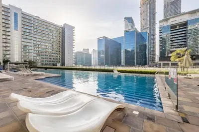 a swimming pool in a city with tall buildings at Vibrant City Living, 1Bedroom with Balcony - Vera Tower, Business Bay by Deluxe Holiday Homes in Dubai