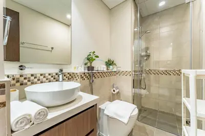 a bathroom with a sink and a shower at Vibrant City Living, 1Bedroom with Balcony - Vera Tower, Business Bay by Deluxe Holiday Homes in Dubai