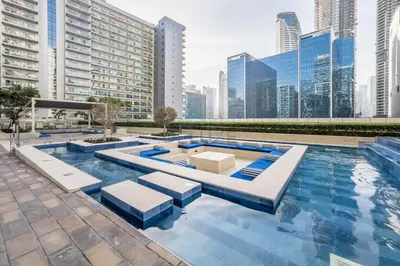 a swimming pool in a city with tall buildings at Vibrant City Living, 1Bedroom with Balcony - Vera Tower, Business Bay by Deluxe Holiday Homes in Dubai