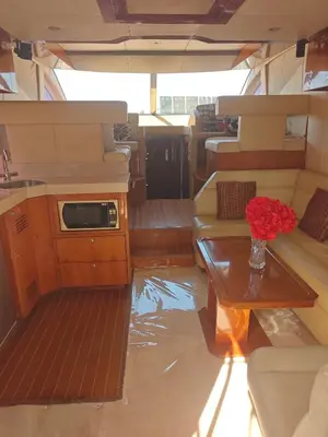 a living room with a vase of flowers on a table at Luxury yacht Stay Dubai in Dubai