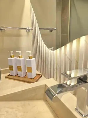 a bathroom with three soap dispensers on a counter at Fairmont The Palm Luxury Apt 2413 in Dubai