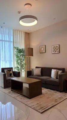a living room with a couch and a coffee table at Contemporary 1 Bedroom in the Heart of Al Furjan-205 in Dubai