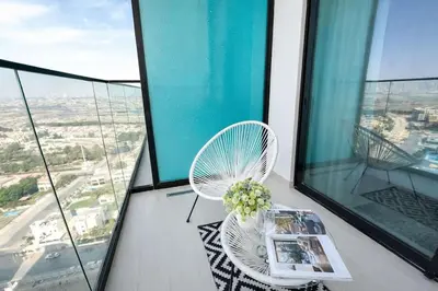 a view from the top of a building with two chairs at Modern Studio in Binghatti Azure with Pool & Gym in Dubai