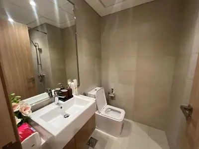 a bathroom with a white toilet and a sink at Stylish & Luxe Studio - AZIZI 19 Riviera-Great Views in Dubai