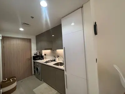 a kitchen with a white refrigerator and a sink at Stylish & Luxe Studio - AZIZI 19 Riviera-Great Views in Dubai