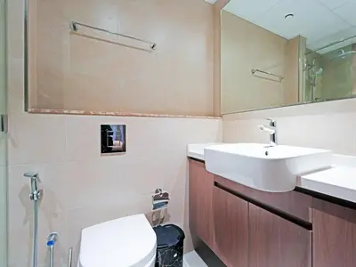 a bathroom with a sink and a toilet and a mirror at Spacious 1BR with Modern Living in Al Furjan-805 in Dubai